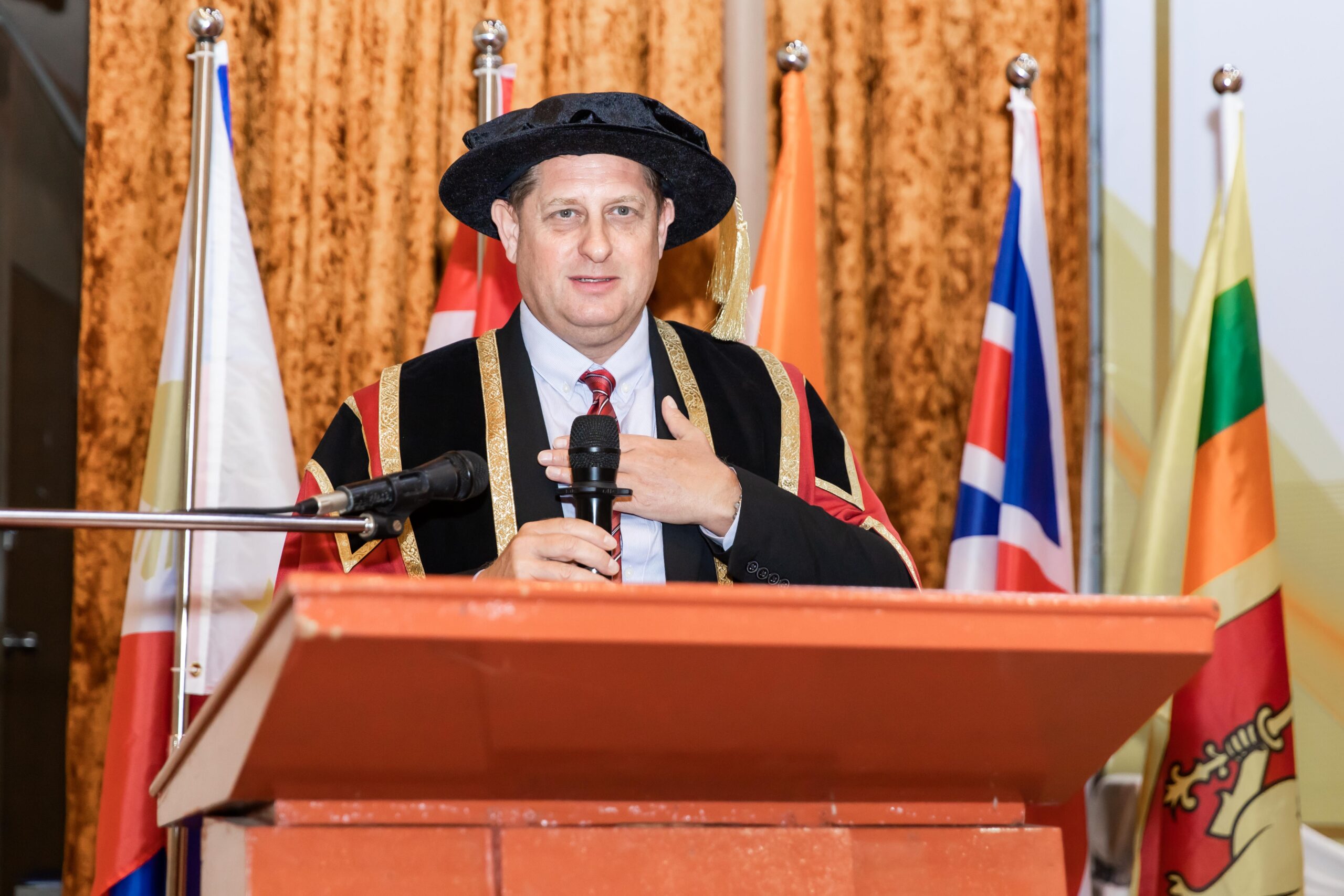 Mr. Martin, Founder and President of IBSS, speaking at the 2026 convocation