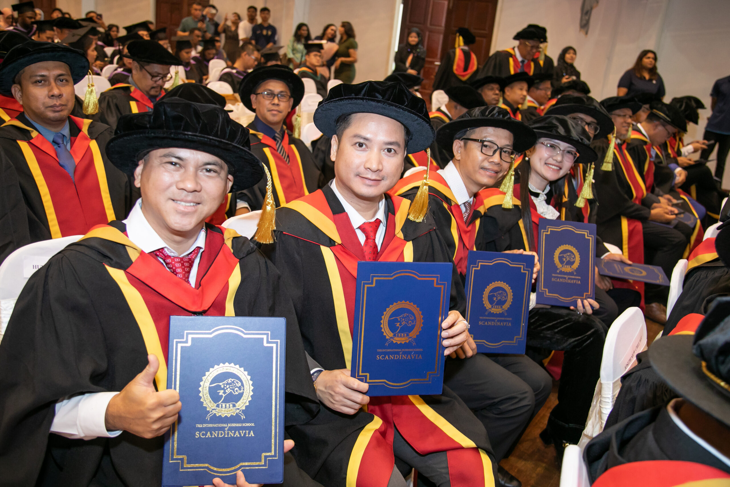 IBSS graduate holding a certificate at the 2026 convocation