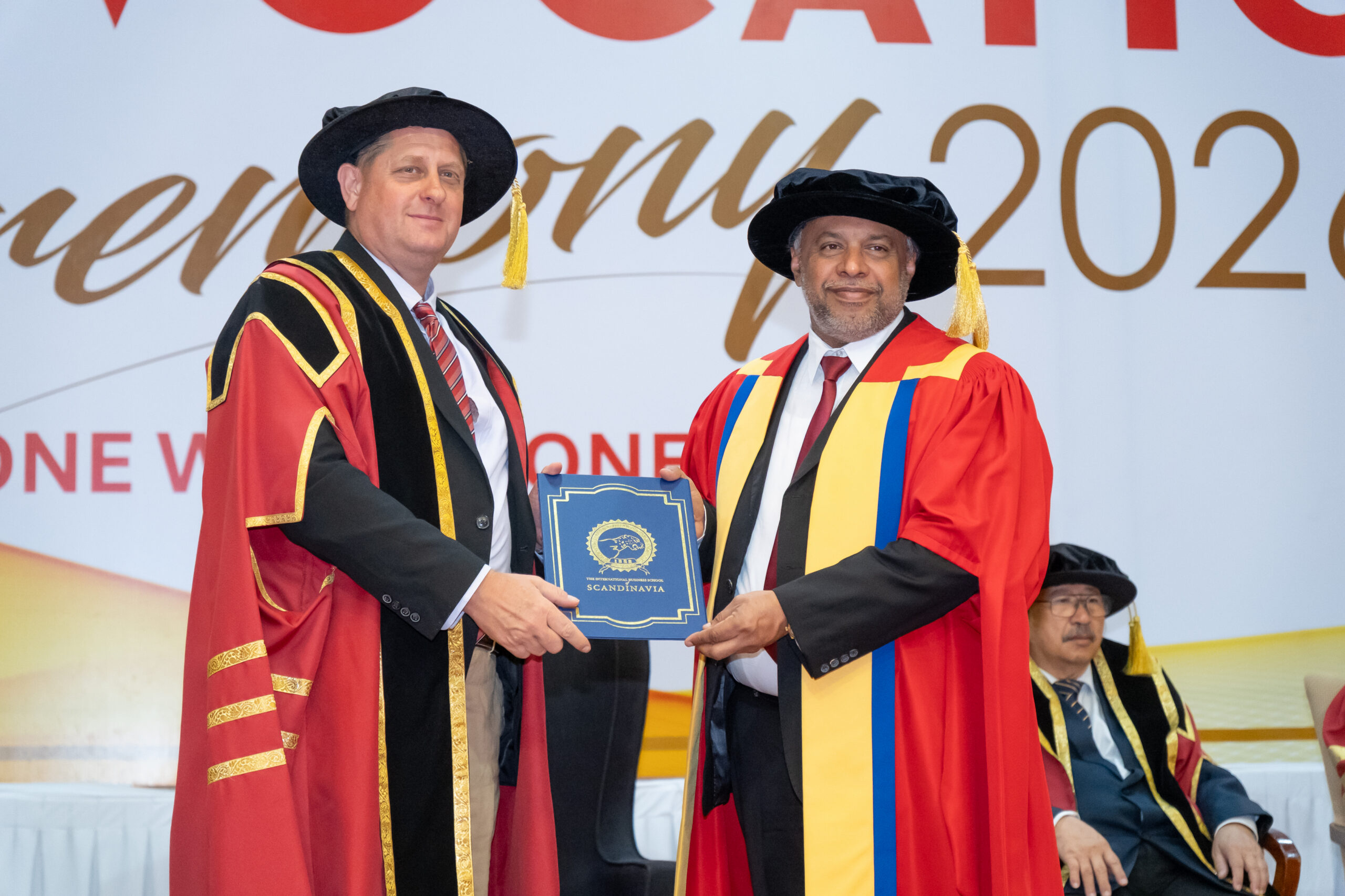 IBSS graduate receiving a certificate on stage at the 2026 convocation